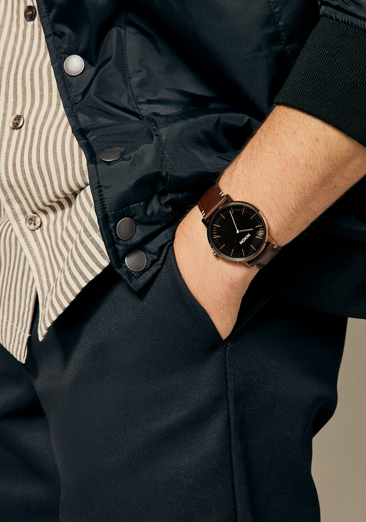 Man wearing a Nixon Porter Leather with his hand in his pocket