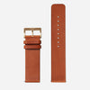 A brown leather Nixon watch band.